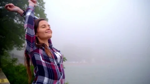 Happy woman relaxing near sea. Beautiful woman breathing fresh air Stock Footage