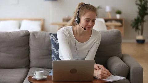 Happy woman sales representative in headset speaking making online call Stock Footage