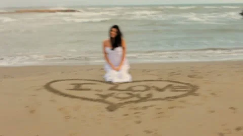 Happy woman saying I love you on the beach Stock Footage