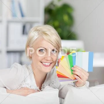 Happy woman showing samples of wall color Stock Photos
