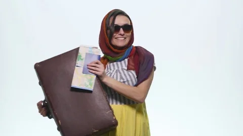 Happy woman showing suitcase passport and map for holiday. White background Stock Footage