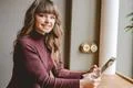The happy woman sitting with a tablet at the restaurant table Photo