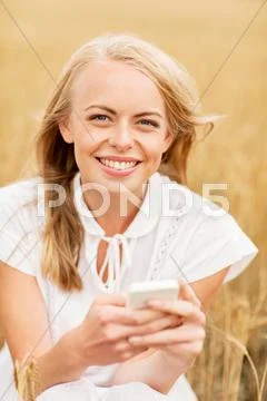 Happy woman with smartphone and earphones Stock Photos