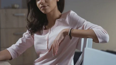 Happy woman smiling at camera while sitting at home in the kitchen. Видео 70648369