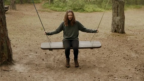Happy woman smiling while swinging in the forest. Active weekend concept. Stock Footage 112166329