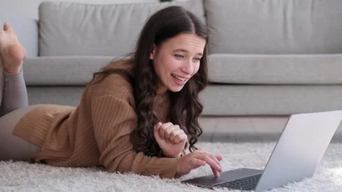 Happy Woman Smiling While Using Laptop on the Living Room Floor Stock Footage 254517278