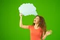The happy woman stand with a virtual dialog on the green background Photo