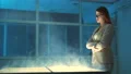 The happy woman standing near the steaming display 4k or 4k+ Resolution
