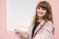 The happy woman standing on the pink wall background Photo