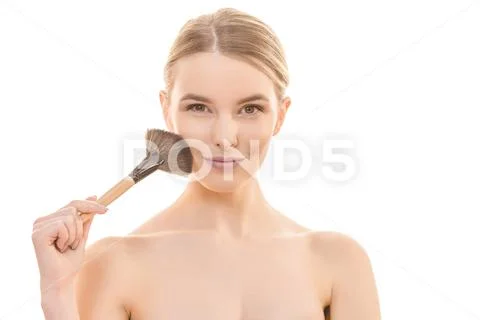 The happy woman using a cosmetic brush on the white background Stock Photos