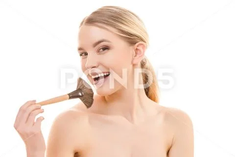 The happy woman using a cosmetic brush on the white background Stock Photos