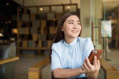 Happy woman using smartphone in cafe Stock Photos