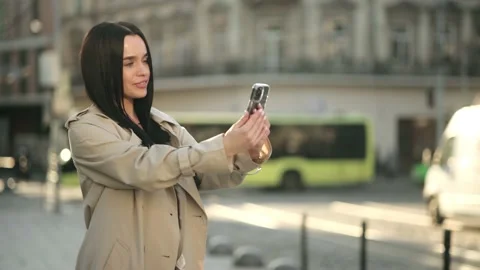 Happy woman using smartphone to do a video call on a summer day while looking at Stock Footage 232047909