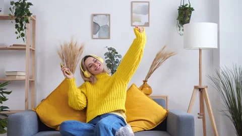 Happy woman using smartphone on sofa Stock Footage 235828512