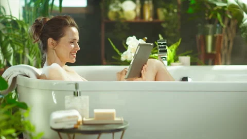 Happy Woman Using Tablet During a Relaxing Bath Stock Footage 332451236