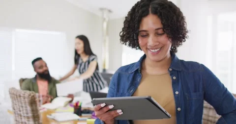 Happy woman using tablet, working with diverse male and female friend, in slow Stock Footage 342111003