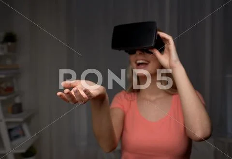 Happy woman in virtual reality headset or glasses Stock Photos