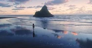 Happy Woman Walking On The Beach At Karekare, Auckland, New Zealand Stock Footage