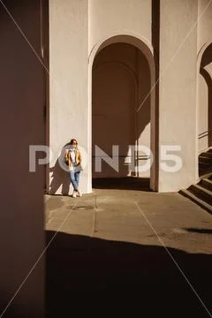 Happy woman walking through the city alone Stock Photos