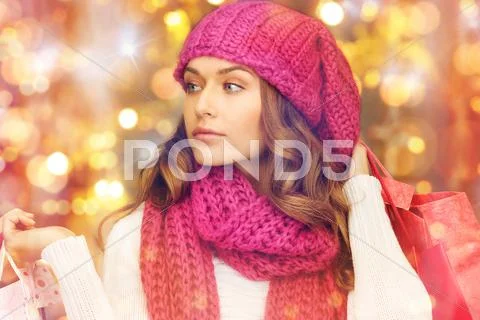 Happy woman in winter clothes with shopping bags Stock Photos