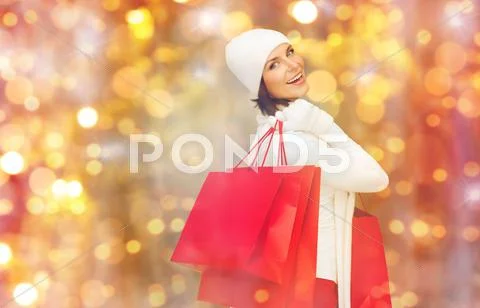 Happy woman in winter clothes with shopping bags Stock Photos