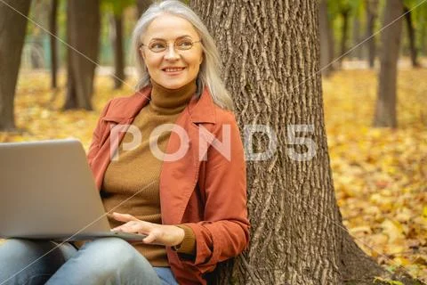 Happy woman working in a city park Stock Photos