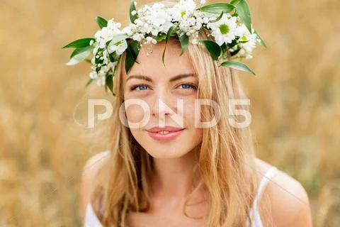 Happy woman in wreath of flowers Stock Photos