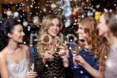 Happy women with champagne glasses at night club Stock Photos