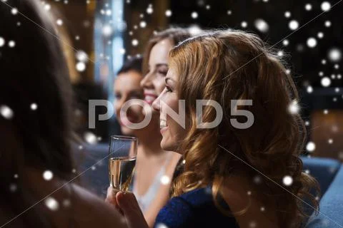 Happy women with champagne glasses at night club Stock Photos