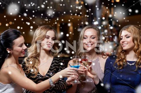 Happy women with drinks at night club Stock Photos