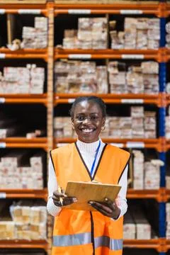 Happy worker checking inventory in lumber warehouse Stock Photos