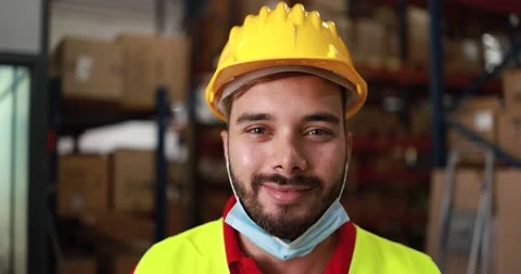 Happy worker man inside warehouse while wearing protective mask Stock Footage 145434595