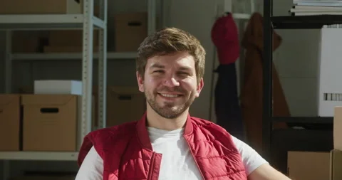 Happy worker of storage sitting and smiling, employee of warehouse, man wearing Stock Footage 157369655