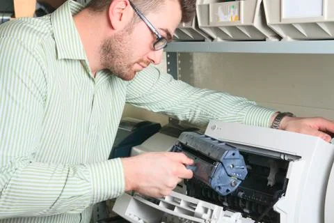 A happy worker technician at work with computer Stock-Fotos