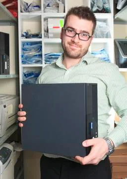 A happy worker technician at work with computer Stock-Fotos