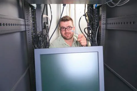 A happy worker technician at work with computer Stock-Fotos