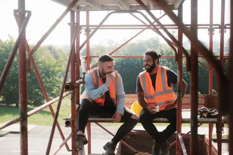 Happy Workers In Construction Site During Lunch Break Stock Photos