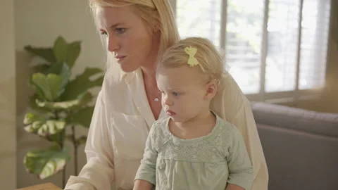 Happy Working Mom Responding to Emails with Daughter on Her Lap Stock Footage 133282974