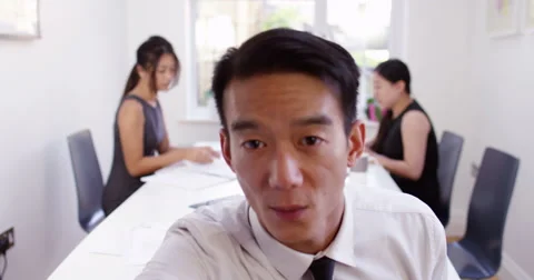 Happy young Asian manager having a video conference from her boardroom. Stock Footage 58688841