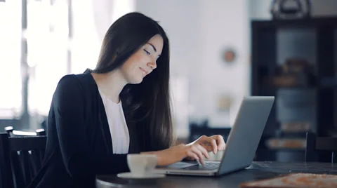 Happy Young Beautiful Woman Using Laptop, Indoors Stock Footage
