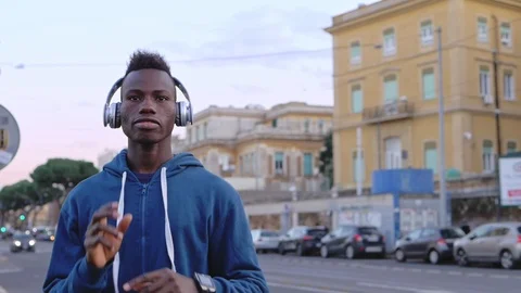 Happy young black man dancing in the street,listening music-slow motion Video stock 105018054