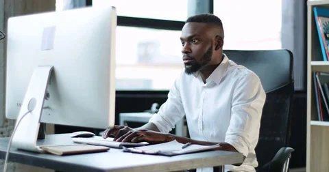 Happy young black man working use computer in office smile technology feeling Stock Footage