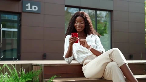 Happy young black woman using cell phone outdoor. Stock Footage 199449765