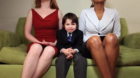 Happy young boy on couch with two  women Stock Footage 1039621