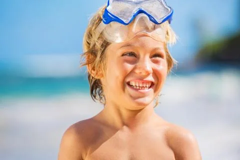 Happy young boy having fun at the beach Stock Photos