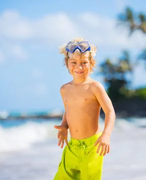 Happy young boy having fun at the beach Stock Photos