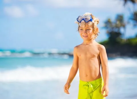 Happy young boy having fun at the beach Stock Photos