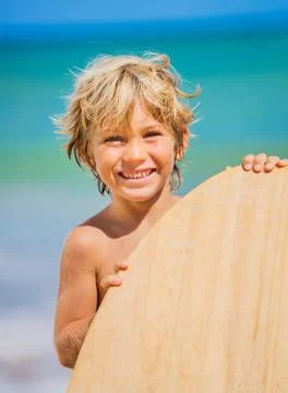 Happy young boy having fun at the beach on vacation Stock Photos