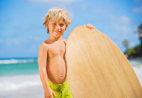 Happy young boy having fun at the beach on vacation Stock Photos