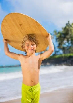 Happy young boy having fun at the beach on vacation Stock Photos